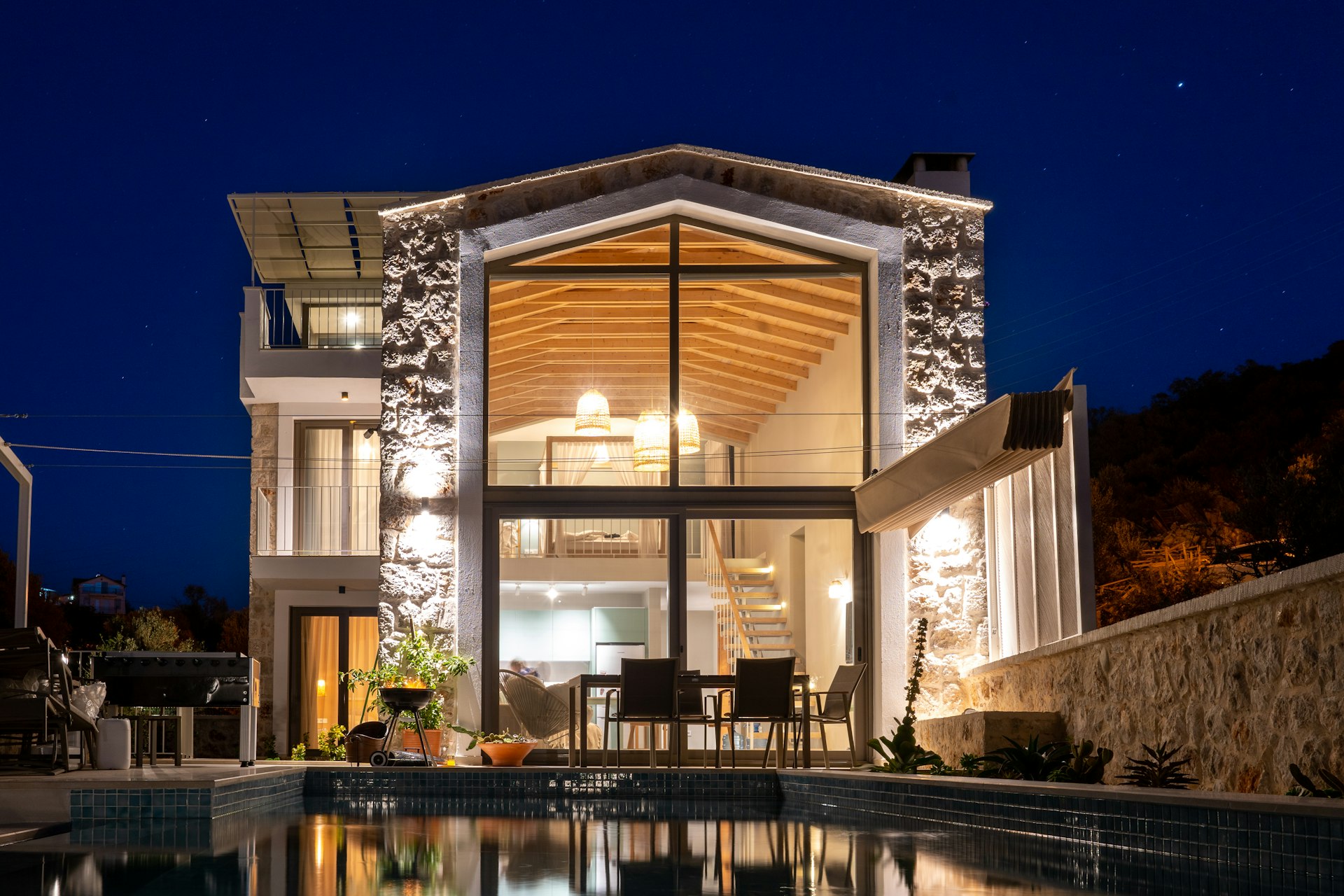 a house with a swimming pool at night